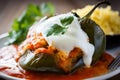 Appetizing close-up of Chiles Rellenos stuffed with shredded chicken and topped with a zesty tomato sauce