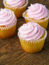 Appetizing cupcakes with pink cream on the table. Close-up. Sweet tasty calorie food. Holiday, surprise, birthday, Valentine`s Da