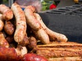 Appetizing delicious fried meat frankfurters sausage on a barbecue grill outdoors.