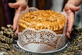 Appetizing delicious wedding loaf in women`s hands