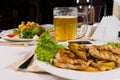 Appetizing Dishes and Beer Mug on Table Royalty Free Stock Photo