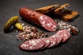 appetizing dry cured salami sausage with rye bread and pickled cucumbers Royalty Free Stock Photo