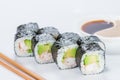 Appetizing fresh sushi rolls with rice, shrimps, avocado and cucumber on light background Royalty Free Stock Photo