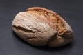 Appetizing freshly baked bread on a black background. loaf of bread close-up