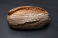 Appetizing freshly baked bread on a black surface. Side view