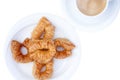 Appetizing freshly made arabic baklava on a white plate with a cup of coffee. View from above. Traditional oriental sweets