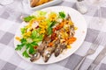 Appetizing fried blue whiting with vegetables