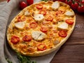 Appetizing golden focaccia with tomatoes, chiken meat, spices on
