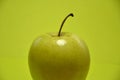 Appetizing green apple on a green background