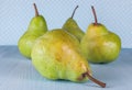 Appetizing green pears on a blue background