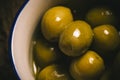 Appetizing green salted olives i a rustic bowl
