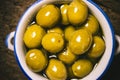 Appetizing green salted olives i a rustic bowl