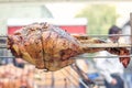 Appetizing grilled pork on the spit. Roasted leg of porkon traditional barbecue. Prepared of a ram pig baked pork meat Street food