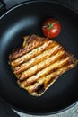 Grilled pork steak and tomato in a pan