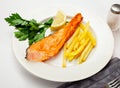 Tasty grilled salmon served with french fries Royalty Free Stock Photo