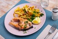 Tasty grilled salmon served with french fries Royalty Free Stock Photo