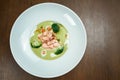 Appetizing and healthy green pea cream soup with broccoli and salmon cooked in a smoker on a wooden background. Top view Royalty Free Stock Photo