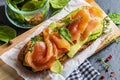 Appetizing and healthy smoked salmon with avocado and vegetables spinach sprouts, tomatoes, thyme on toast. Homemade look. Top Royalty Free Stock Photo