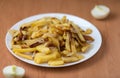 Appetizing home fried potatoes with onions served on a white plate