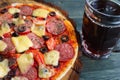 Appetizing homemade pizza with salami, cheese and olives and mug Royalty Free Stock Photo