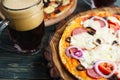 Appetizing homemade pizza with salami, mozzarella and olives and Royalty Free Stock Photo