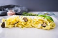 Appetizing Italian Fettuccine Pasta with slices of black truffle and grated Parmesan cheese on a white plate. Royalty Free Stock Photo
