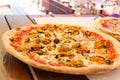 Appetizing italian seafood pizza. Delicious pizza with mussels Royalty Free Stock Photo