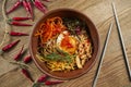 Appetizing Korean food - Bibimbap served as a bowl of warm white rice topped with namul, kimchi, chili pepper paste, soy sauce, Royalty Free Stock Photo
