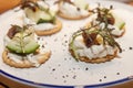Appetizing little canapes on a plate. Close-up