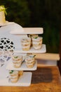 Appetizing looks more cakes in cups on a white stand at the holiday Royalty Free Stock Photo