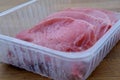 Appetizing meat pork and beef entrecotes lie in a factory plastic tray, the concept of raw meat products, shopping for ingredients