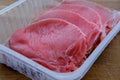 Appetizing meat pork and beef entrecotes lie in a factory plastic tray, the concept of raw meat products, shopping for ingredients