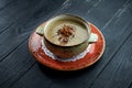 Appetizing mushroom cream soup with olive oil and fried mushrooms, served in a bowl on a black background. Diet food Royalty Free Stock Photo