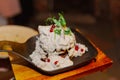 Appetizing pancakes from potatoes doused with sour cream sauce with white mushrooms and red berries with greens upstairs