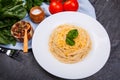 Appetizing pasta, a branch of tomatoes, a few bunches of herbs and spices.