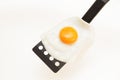 Appetizing and Perfectly Fried Egg on a Spatula, isolated on white background Royalty Free Stock Photo
