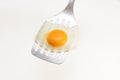Appetizing and Perfectly Fried Egg on a Spatula, isolated on white background Royalty Free Stock Photo