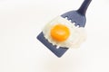 Appetizing and Perfectly Fried Egg on a Spatula, isolated on white background Royalty Free Stock Photo