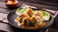 Chinese dumplings on a plate with sauce on a wooden background. Generative AI. Royalty Free Stock Photo