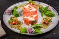 Appetizing pink salmon roll with cream cheese and shrimp meat with ricotta pesto sauce with fresh basil. Delicious seafood