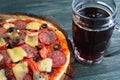 Appetizing pizza with salami, mozzarella and olives and mug of s Royalty Free Stock Photo