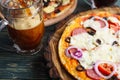 Appetizing pizza with salami, mozzarella and olives and two mugs Royalty Free Stock Photo