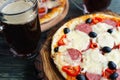 Appetizing pizza with salami, mozzarella and olives and two mugs Royalty Free Stock Photo