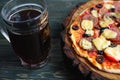 Appetizing pizza with salami, mozzarella and olives and two mugs Royalty Free Stock Photo