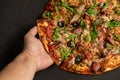 Appetizing pizza with smoked sausages bacon meat tomato cheese arugula Royalty Free Stock Photo