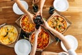 Appetizing pizza on the table and hands above it Royalty Free Stock Photo
