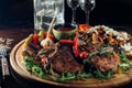 Appetizing plate with beef steaks with potatoes, hot chili peppers, beans and young potatoes, onions, cheese, pickled cucumners Royalty Free Stock Photo