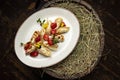 Appetizing plate of fluffy pancakes with a delicious filling topped with sweet strawberries Royalty Free Stock Photo