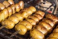 Appetizing potatoes are baked on hot coals