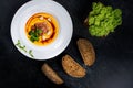 An appetizing pumpkin soup is served in a white plate in a restaurant Royalty Free Stock Photo